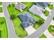 Overhead view of beautiful gray home with well-kept lawn and street, surrounded by other similar homes in the neighborhood at 5868 Wood Stork Way, The Villages, FL 32163