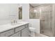 Clean bathroom with gray vanity, white countertop, and glass shower at 5868 Wood Stork Way, The Villages, FL 32163