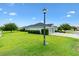 This home features a lush front lawn, manicured shrubs, and a well-maintained exterior at 5868 Wood Stork Way, The Villages, FL 32163