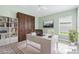 Bright home office with custom bookshelves, statement desk, and large window at 5868 Wood Stork Way, The Villages, FL 32163