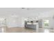 Spacious kitchen featuring gray cabinetry, stainless steel appliances, a large island, and an open layout at 5868 Wood Stork Way, The Villages, FL 32163