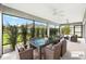Covered lanai with ample seating and dining options with beautiful backyard views at 5868 Wood Stork Way, The Villages, FL 32163
