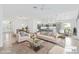 Bright living room features stylish furnishings, an open layout, and a view of the dining area at 5868 Wood Stork Way, The Villages, FL 32163