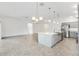 Open concept living space featuring a kitchen with a large island, stainless steel appliances and an open floorplan at 5868 Wood Stork Way, The Villages, FL 32163