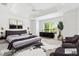 Airy bedroom with tray ceiling, modern accents, decorative rug, and plenty of natural light at 5868 Wood Stork Way, The Villages, FL 32163