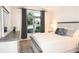 Comfortable bedroom with large window offering natural light and neutral decor at 6301 Danielson Loop, The Villages, FL 32163