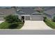 Beautiful single-story home with manicured landscaping and a spacious driveway at 6301 Danielson Loop, The Villages, FL 32163