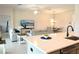 Open-concept design from kitchen island, with seating, to the living and dining areas at 6301 Danielson Loop, The Villages, FL 32163