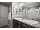 Bathroom with double sinks, granite countertop, and shower at 6342 Whittle Ct, The Villages, FL 32163