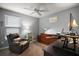 Cozy bedroom designed as a home office with a ceiling fan and relaxing gray color scheme at 6342 Whittle Ct, The Villages, FL 32163