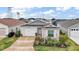 Charming single-story home with well-manicured landscaping, a two-car garage, and inviting curb appeal at 6342 Whittle Ct, The Villages, FL 32163