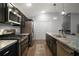 Kitchen with stainless steel appliances, granite countertops, and wood floors at 6342 Whittle Ct, The Villages, FL 32163