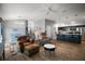 Open-concept living area connecting a stylish kitchen with a cozy seating arrangement and hardwood floors at 6342 Whittle Ct, The Villages, FL 32163