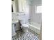 Cozy bathroom with patterned tile flooring and classic white fixtures at 679 Avenue Q Se, Winter Haven, FL 33880