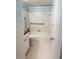 The bathroom features a tiled shower/tub, neutral flooring, grab bars, and provides a clean and functional space at 679 Avenue Q Se, Winter Haven, FL 33880