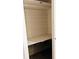 Interior view of an empty closet with shelving and white paneling on the walls, ready for storage at 679 Avenue Q Se, Winter Haven, FL 33880