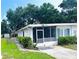 Charming home featuring a screened in porch and well-manicured lawn at 679 Avenue Q Se, Winter Haven, FL 33880