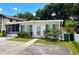 Quaint single-story home with tidy landscaping, an enclosed porch, and inviting front walkway at 679 Avenue Q Se, Winter Haven, FL 33880