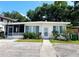 Cozy single-story home with a screened-in porch, tidy landscaping, and a well-maintained walkway at 679 Avenue Q Se, Winter Haven, FL 33880