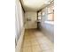 Enclosed porch featuring windows with gray block walls and tile flooring, plus a small window A/C unit at 679 Avenue Q Se, Winter Haven, FL 33880