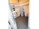 View of the utility room features a hot water heater, shelving, and necessary equipment for home maintenance at 679 Avenue Q Se, Winter Haven, FL 33880