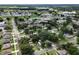 Aerial view of a neighborhood featuring houses, streets, trees and a lake in the distance at 780 N Kentucky Ave, Umatilla, FL 32784