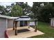 Backyard patio area with a gazebo and lush green trees at 780 N Kentucky Ave, Umatilla, FL 32784