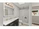 Bright bathroom features wood-look flooring, a shower and a skylight for natural illumination at 780 N Kentucky Ave, Umatilla, FL 32784