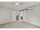 Bedroom featuring carpet floors, open closet and barn style bathroom door at 780 N Kentucky Ave, Umatilla, FL 32784
