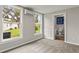 Bright bedroom featuring carpet floors, ensuite bathroom, and two double hung windows at 780 N Kentucky Ave, Umatilla, FL 32784