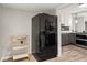 Kitchen area with black stainless steel refrigerator, bar cart, and views to the adjacent kitchen at 780 N Kentucky Ave, Umatilla, FL 32784