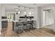 Modern kitchen featuring a breakfast bar with stylish seating, white cabinetry, and stainless appliances at 780 N Kentucky Ave, Umatilla, FL 32784