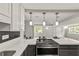 Kitchen with quartz countertops, black appliances, and open view to the living area at 780 N Kentucky Ave, Umatilla, FL 32784