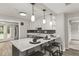 Eat-in kitchen with counter seating, three pendant lights above the counter and stainless steel appliances at 780 N Kentucky Ave, Umatilla, FL 32784
