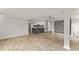 Spacious living room with open floor plan, hardwood floors, and a modern kitchen at 780 N Kentucky Ave, Umatilla, FL 32784