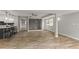 Bright living area with hardwood flooring, open to kitchen bar and featuring modern lighting at 780 N Kentucky Ave, Umatilla, FL 32784
