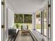 Inviting sunroom features a cozy seating area and views of the lush backyard at 780 N Kentucky Ave, Umatilla, FL 32784