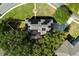 Top-down view of house with solar panels on the roof surrounded by trees and manicured landscaping at 800 Daybreak Dr, Fruitland Park, FL 34731