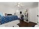 Bright bedroom with stylish furniture, ceiling fan, closet storage, and a view into another room at 800 Daybreak Dr, Fruitland Park, FL 34731