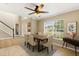Dining room with a ceiling fan, large windows, and a wood dining table at 800 Daybreak Dr, Fruitland Park, FL 34731