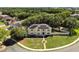 Aerial shot of a two-story home featuring solar panels, a well-maintained yard, and a charming brick walkway at 800 Daybreak Dr, Fruitland Park, FL 34731