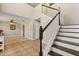 Open foyer with staircase, tile floors, and access to living areas at 800 Daybreak Dr, Fruitland Park, FL 34731