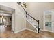 Foyer with stairs, neutral paint, and access to the garage at 800 Daybreak Dr, Fruitland Park, FL 34731