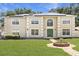 Charming two-story home featuring a well-maintained lawn, green door, and solar panels at 800 Daybreak Dr, Fruitland Park, FL 34731