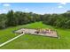 Aerial view of fenced playground features swings, colorful play structures, a bench, and lush surrounding greenery at 800 Daybreak Dr, Fruitland Park, FL 34731