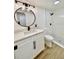 Bathroom featuring white vanity, black hardware, and glass-enclosed shower at 8203 Bluestar Cir, Orlando, FL 32819