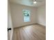 Cozy bedroom with hardwood floors and bright window providing natural light at 8203 Bluestar Cir, Orlando, FL 32819