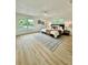 Spacious bedroom featuring wood floors, an area rug, and two windows offering natural light at 8203 Bluestar Cir, Orlando, FL 32819