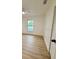Bright bedroom with wood-look flooring, a window offering natural light, and closet at 8203 Bluestar Cir, Orlando, FL 32819