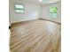 Bright bedroom with wood-look flooring and two windows offering natural light at 8203 Bluestar Cir, Orlando, FL 32819